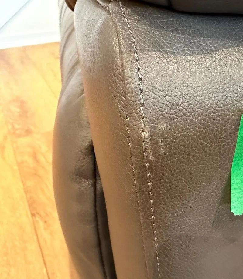 Before: Leather armrest: scuffed seam restored