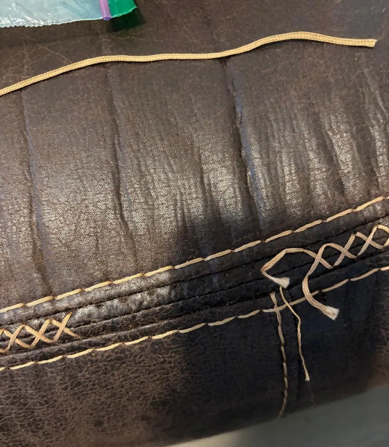 Before: Leather cushion: broken stitching redone